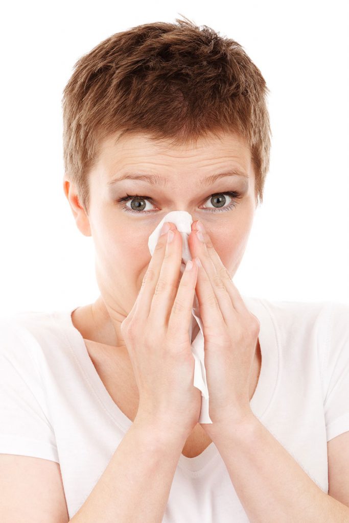 woman blowing nose allergy cold disease flu Columbia allergy and Asthma Specialists in Columbia MO woman blowing nose allergy cold disease flu Columbia allergy and Asthma Specialists in Columbia MO